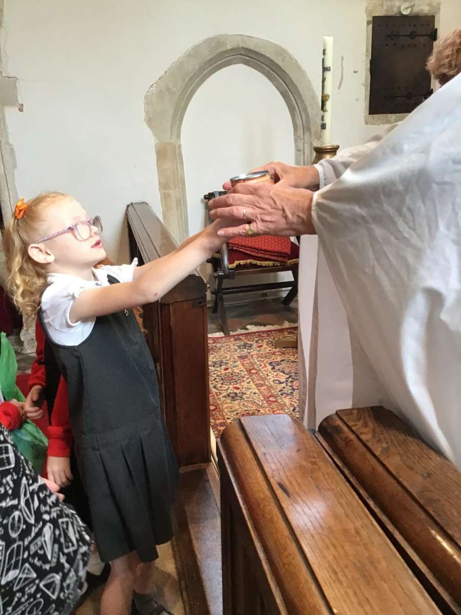 Child receiving blessing in church