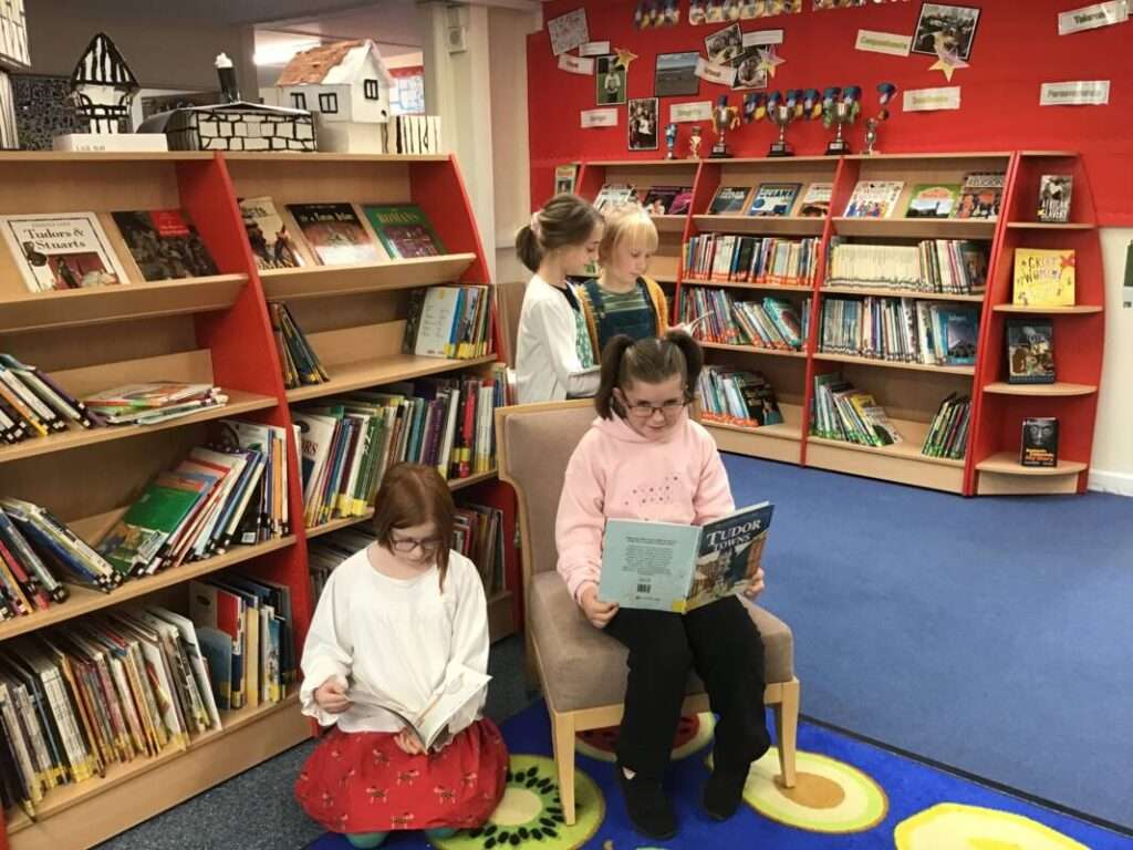 Children reading in a library setting.