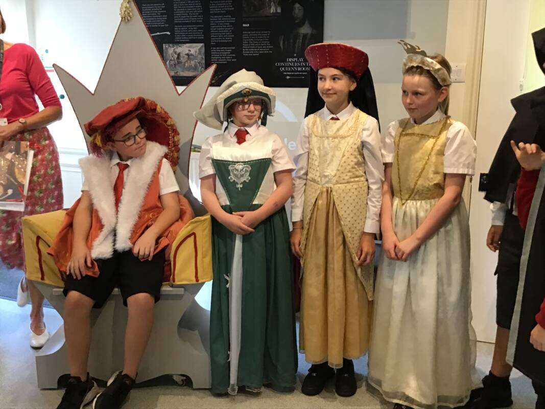 Children in historical costumes posing.