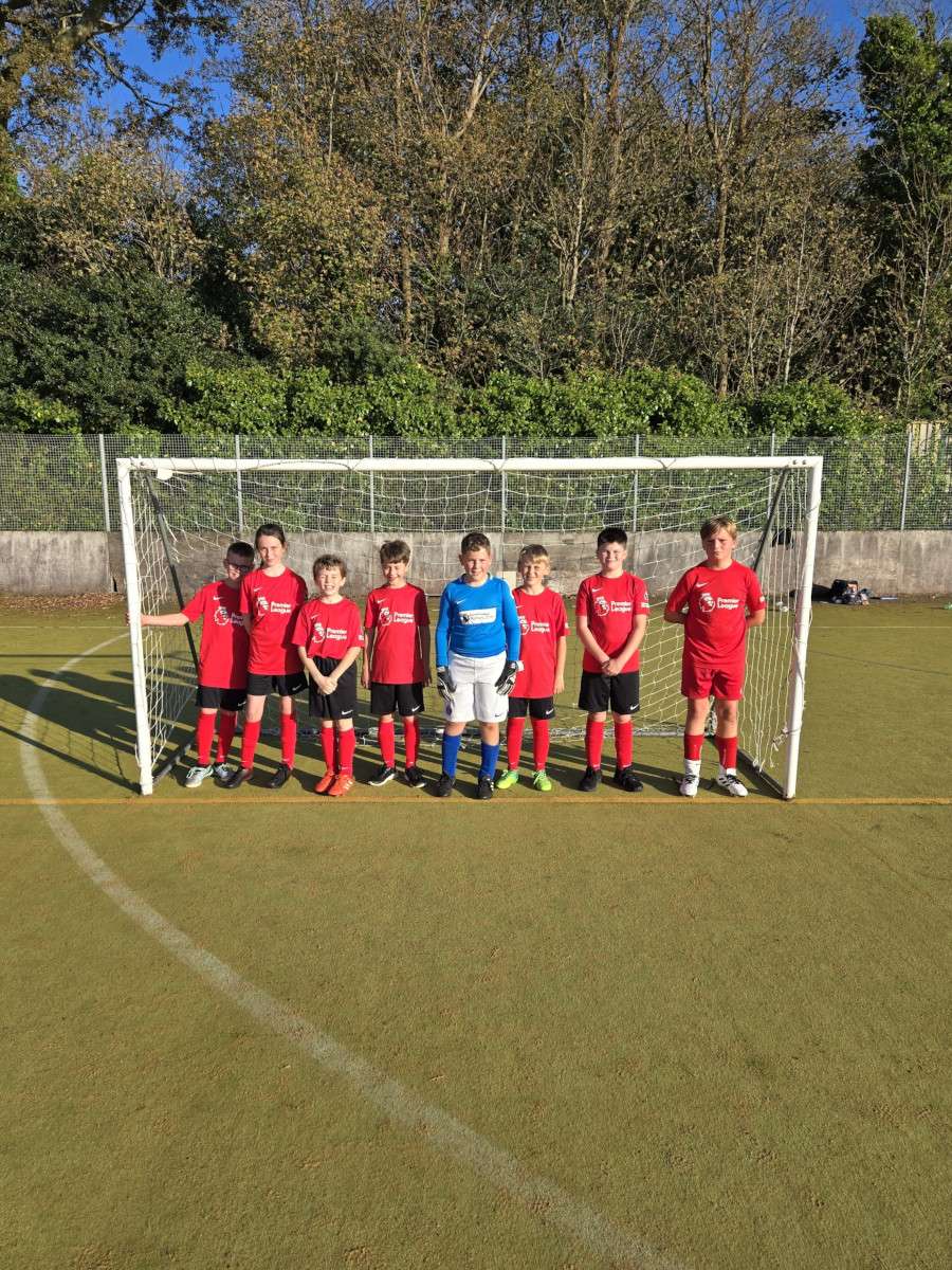 Children football players standing in goal mouth